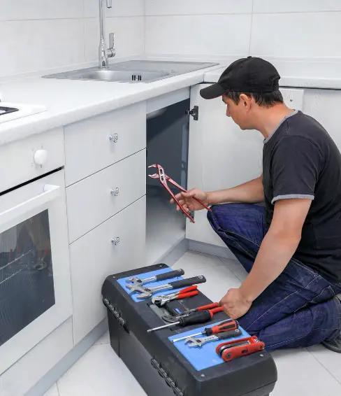 Plumber fixing sink in kitchen plumbing service Lewisville