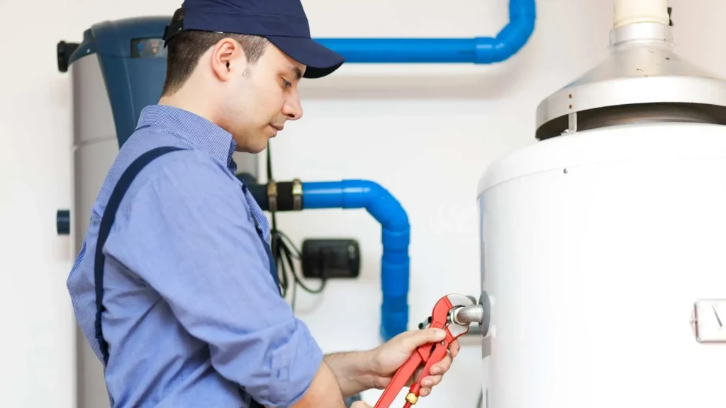 Plumber fixing water heater pipes and connections