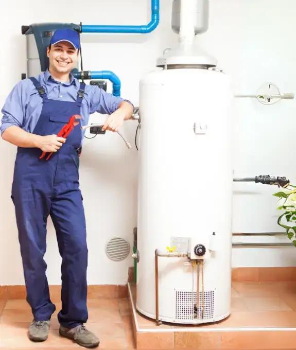 Technician replacing old water heater tank with a new unit